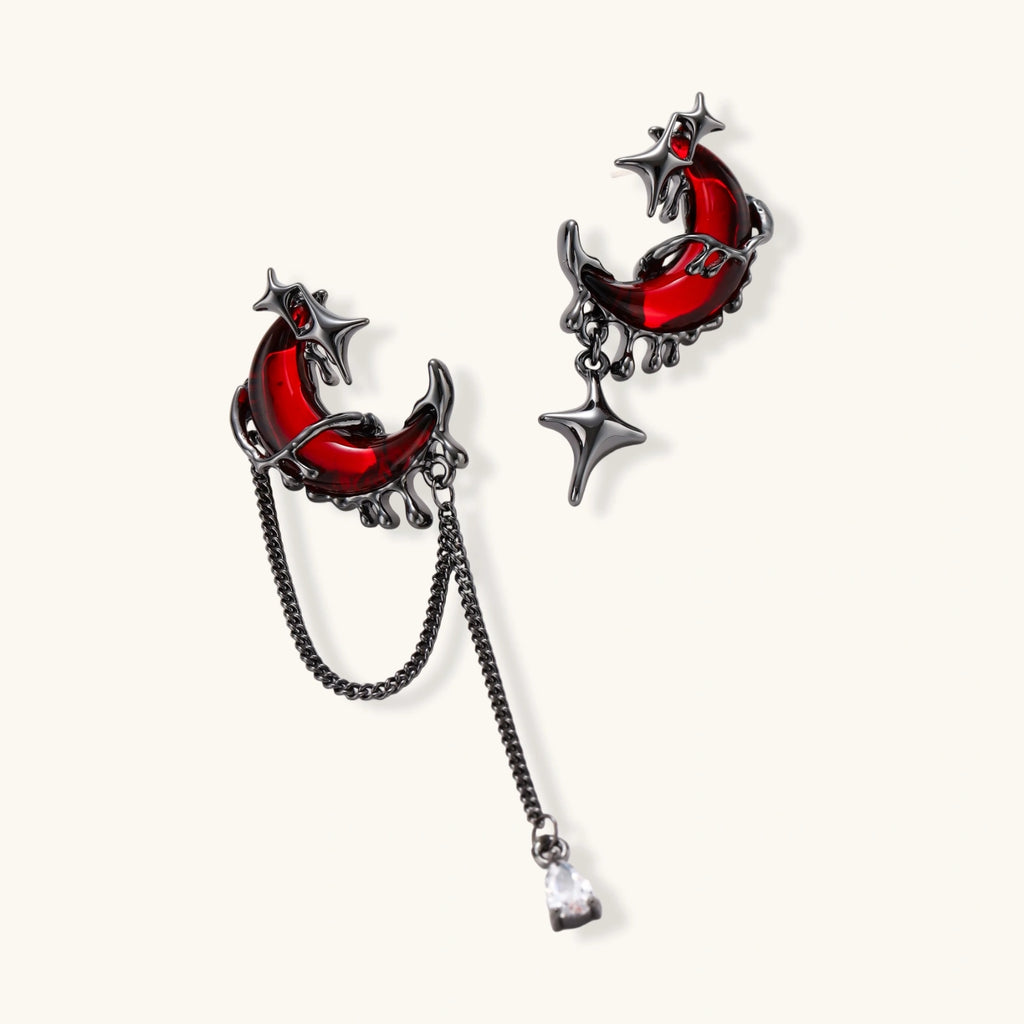 Gothic jewelry set with asymmetrical black metal earrings featuring red crescent moons, stars, and layered necklaces with heart pendants
